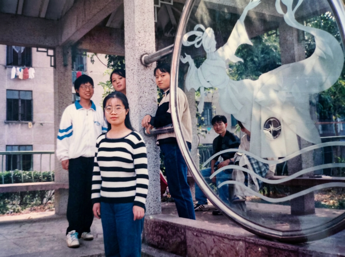 AI enhanced repair of an old class group photo from three decades ago. Erase scratches, dust spots, and color degradation seamlessly. Enhance clarity for every individual in the crowd without altering their true appearances or merging faces. Preserve authentic expressions, natural lighting, and retro school background aesthetics. Masterpiece, ultra-detailed.